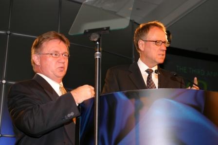 Brick President and CEO Kim Yost and Leadership Success Coach Bob 'Idea Mah' Hooey speaking at a special awards evening for Bill Comrie